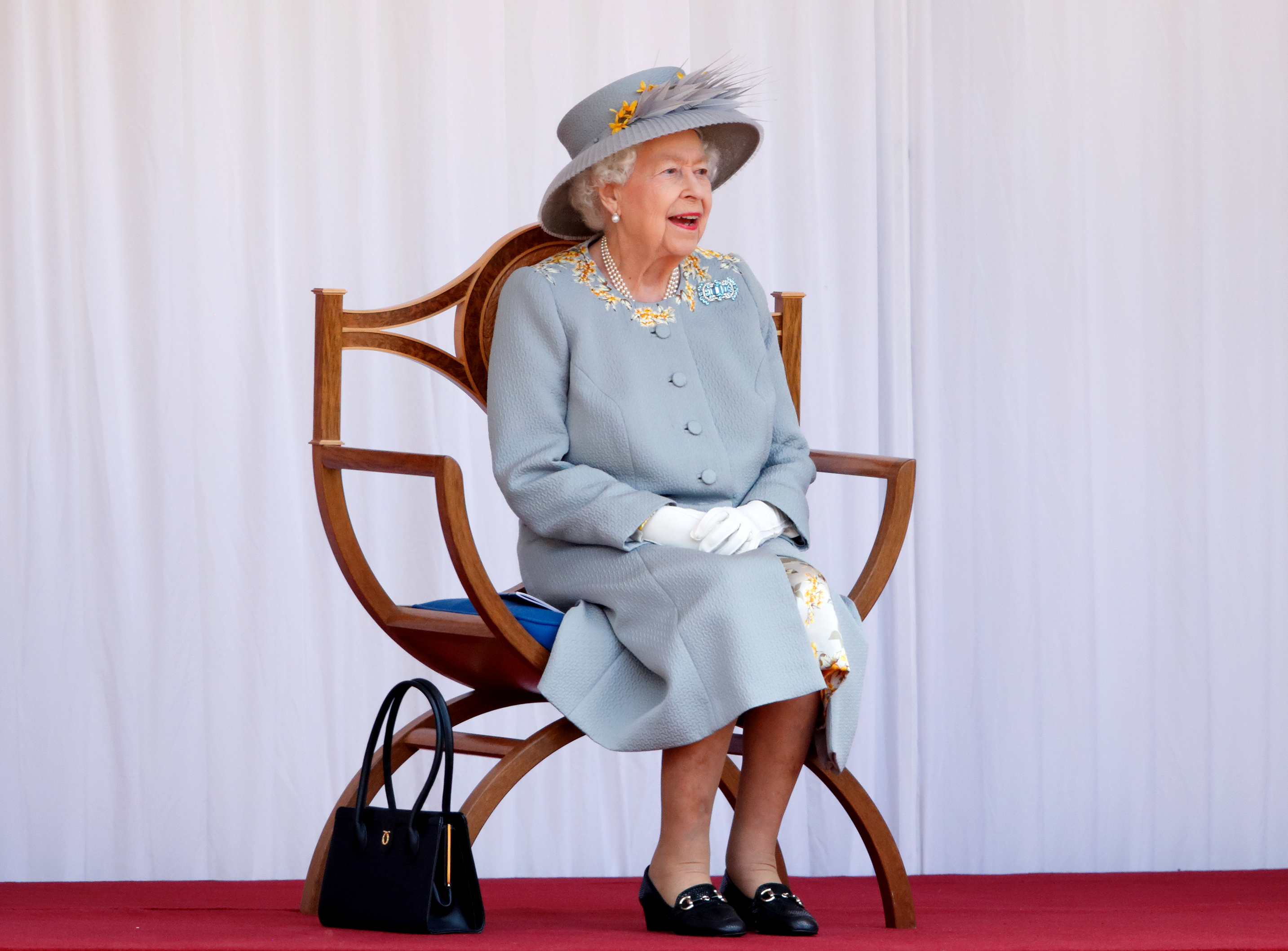 WINDSOR, UNITED KINGDOM - JUNE 12: (EMBARGOED FOR PUBLICATION IN UK NEWSPAPERS UNTIL 24 HOURS AFTER CREATE DATE AND TIME) Queen Elizabeth II watches a flypast by the RAF Red Arrows as she attends a military parade, held by the Household Division (during which The Queen&amp;amp;apos;s Colour of F Company Scots Guards will be trooped) in the Quadrangle of Windsor Castle, to mark her Official Birthday on June 12, 2021 in Windsor, England. For the second consecutive year The Queen&amp;amp;apos;s Birthday Parade, known as Trooping the Colour, hasn&amp;amp;apos;t been able to go ahead in it&amp;amp;apos;s traditional form at Buckingham Palace and Horse Guards Parade due to the ongoing COVID-19 Pandemic. (Photo by Max Mumby/Indigo - Pool/Getty Images)