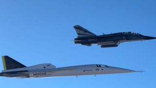 a white aircraft flies under blue skies