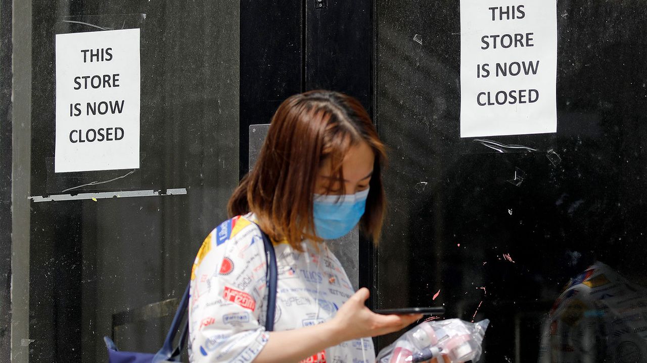 © Woman outside a closed shop