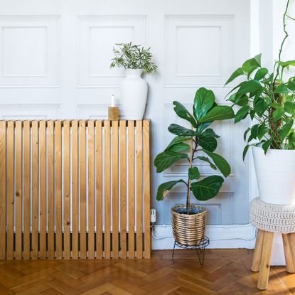 DIY wooden radiator cover over radiator in panelled wall living room