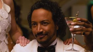 Koumba holding martini in James Bond mode in Pluribus Episode 6