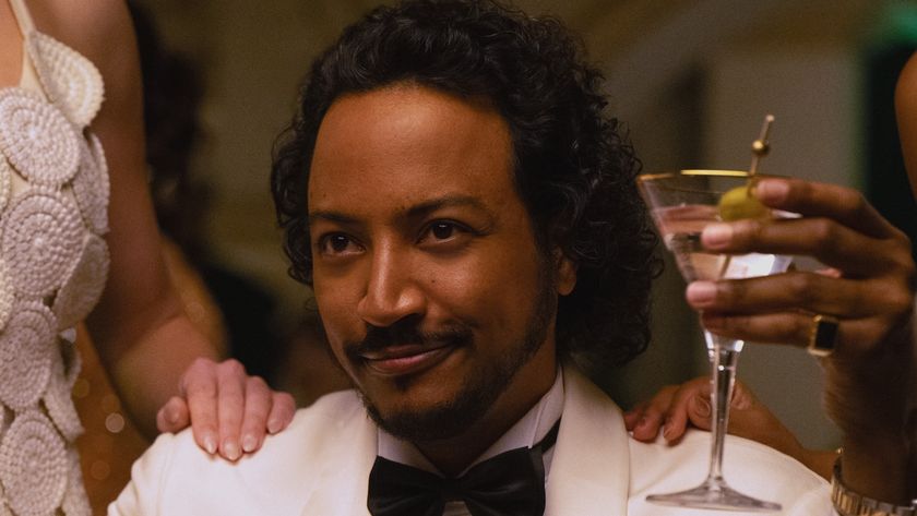 Koumba holding martini in James Bond mode in Pluribus Episode 6