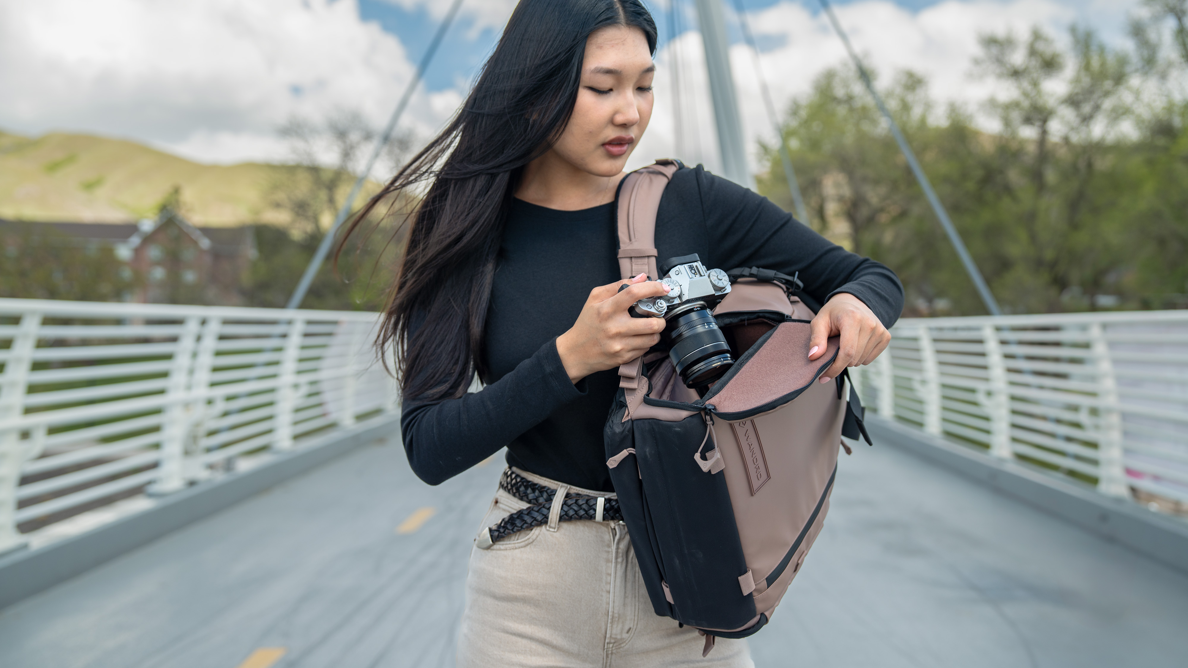 The Wandrd Prvke camera backpack side access door being used by a photographer