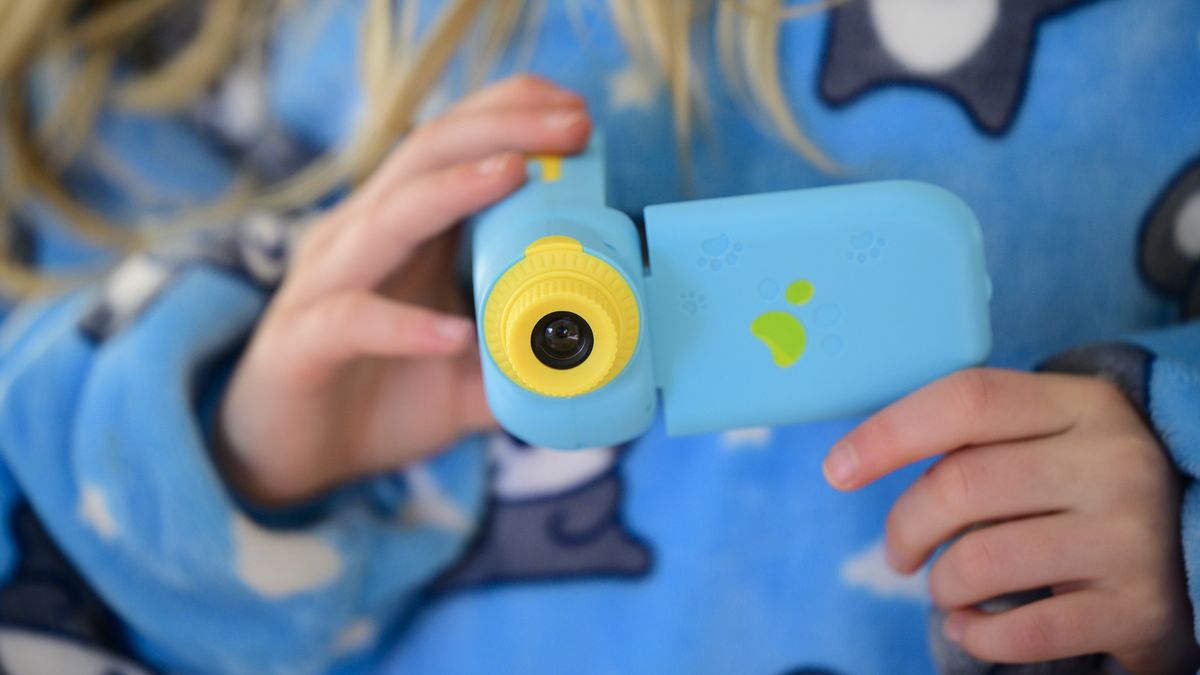 Cheap blue kids camera in the hand