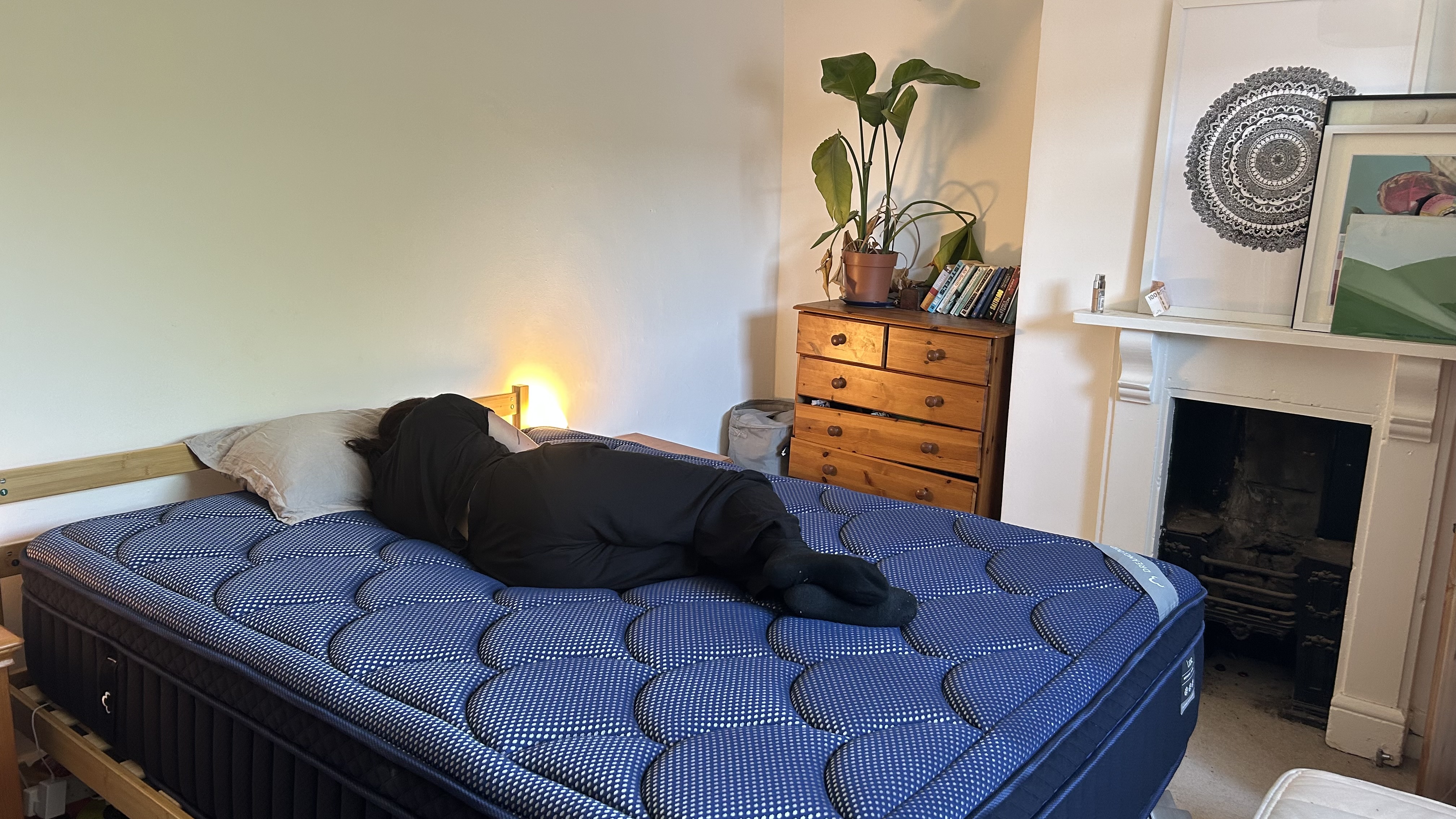 Our mattress tester assessing the comfort and support of the DreamCloud Luxe Memory Foam mattress by lying on her side
