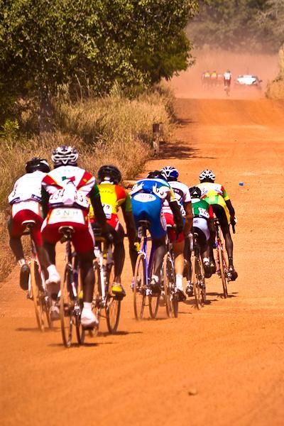 Groups scattered up and down the road leading into Koudougou