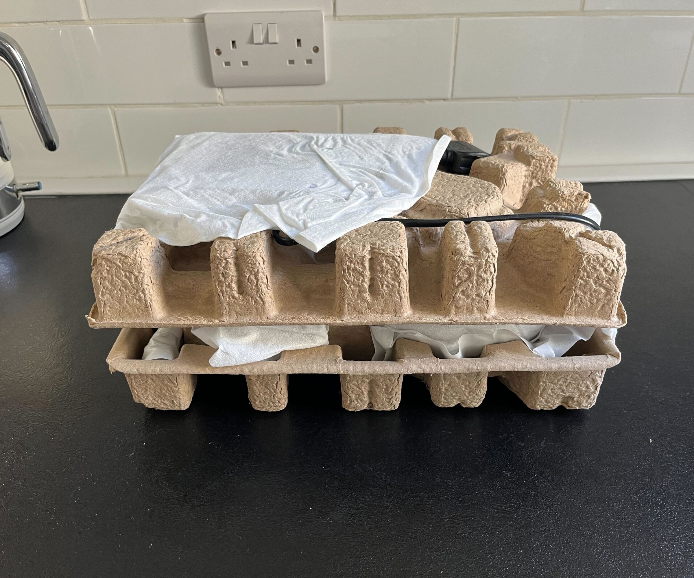 Brown cardboard packaging on a black counter. 