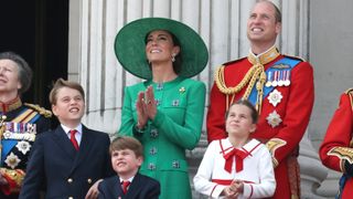 Prince George of Wales, Prince Louis of Wales, Princess Charlotte of Wales, Catherine, Princess of Wales and Prince William, Prince of Wales stand on the balcony of Buckingham Palace