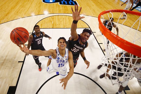 A Duke player tries to make a slam dunk.