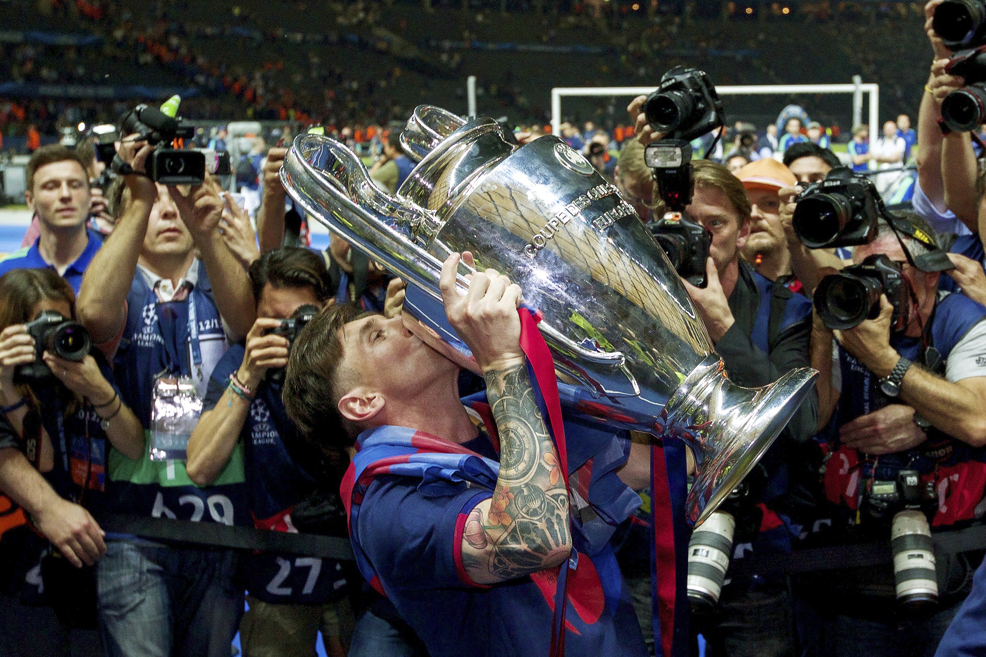 Lionel Messi kisses the Champions League trophy after Barcelona's win over Juventus in the 2015 final in Berlin.