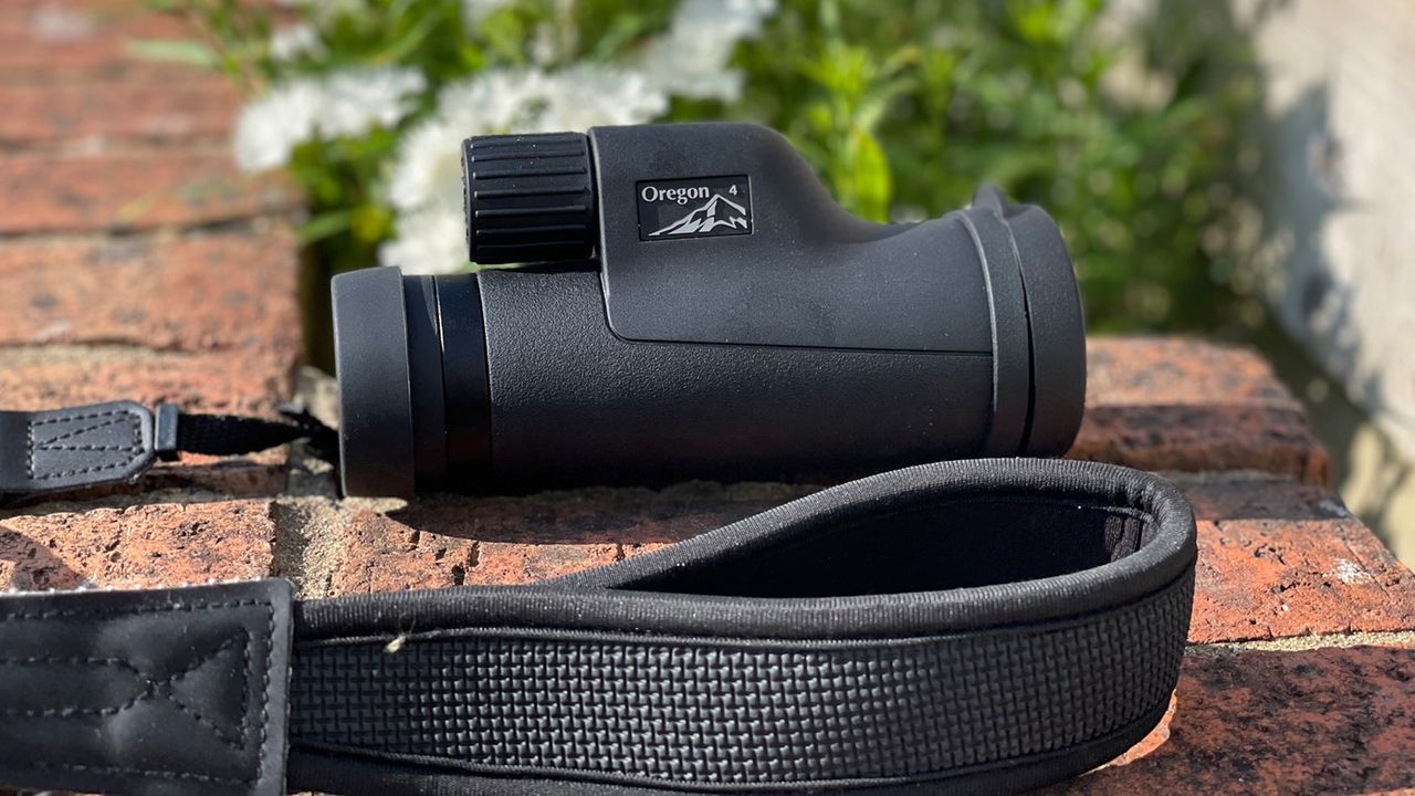 Opticron Oregon 4 PC Oasis 10X42 on a wall and showing the shoulder strap
