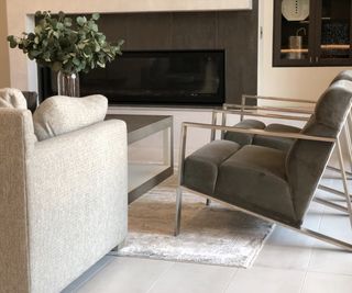 Living room with light gray couch, dark gray armchairs and light gray rug