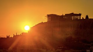 The sunset overlooking the Acropolis of Athens in Greece