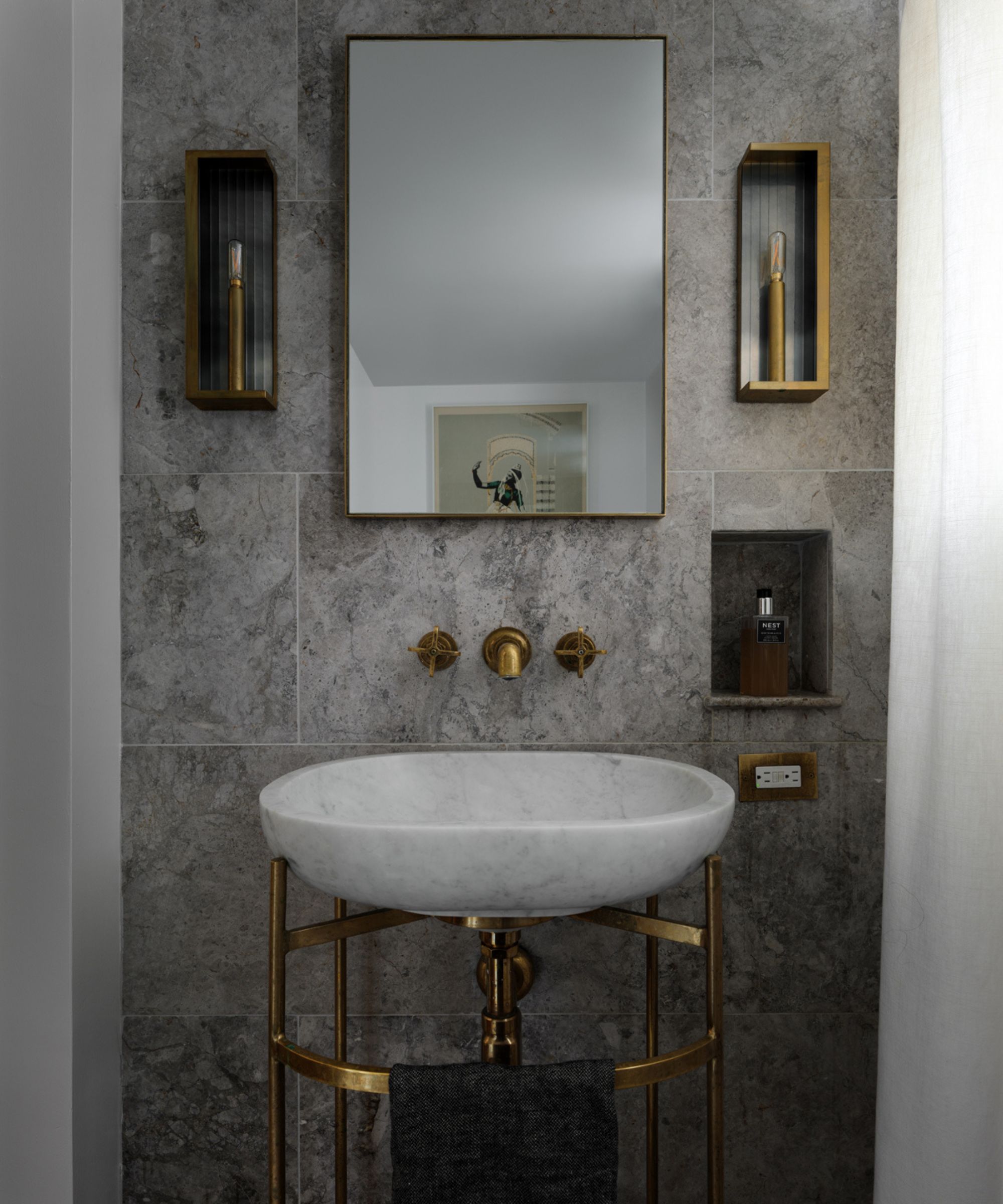 A traditional bathroom vanity with a brass stand