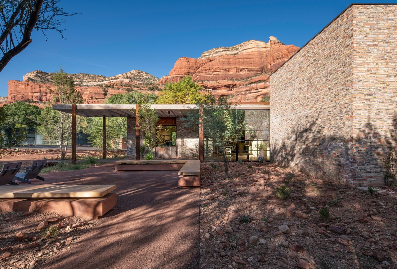 Exterior of Trail House by Gluckman Tang among vegetation