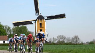 A countryside shot, featuring a Dutch windmill, of the Amstel Gold Race.
