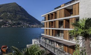 Looking out past the wooden-fronted hotel and balconies towards Lake Como