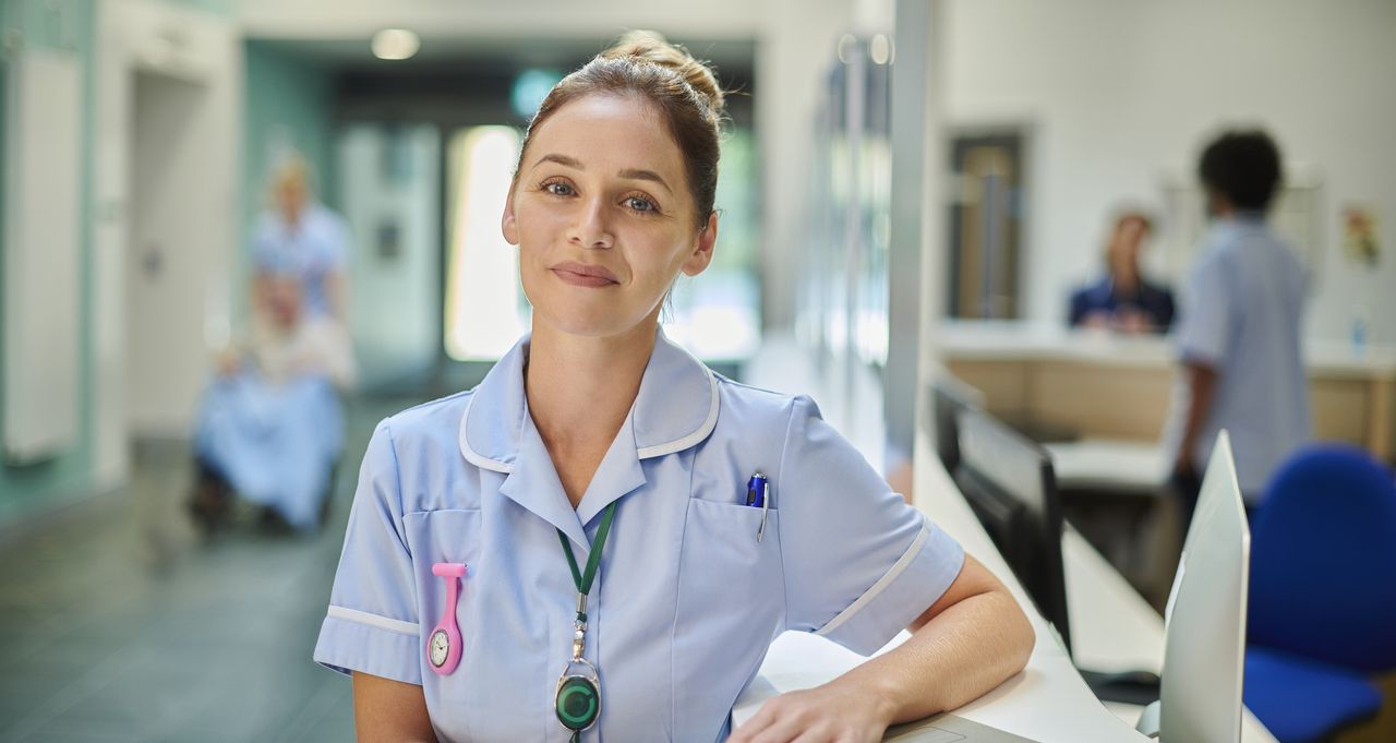 A smiling nurse working in a hospital.