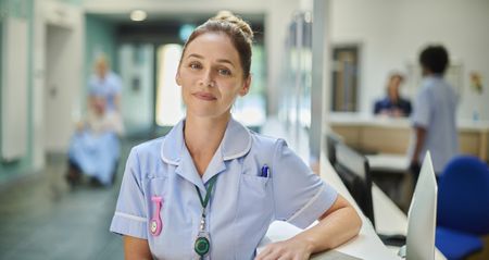 A smiling nurse working in a hospital.