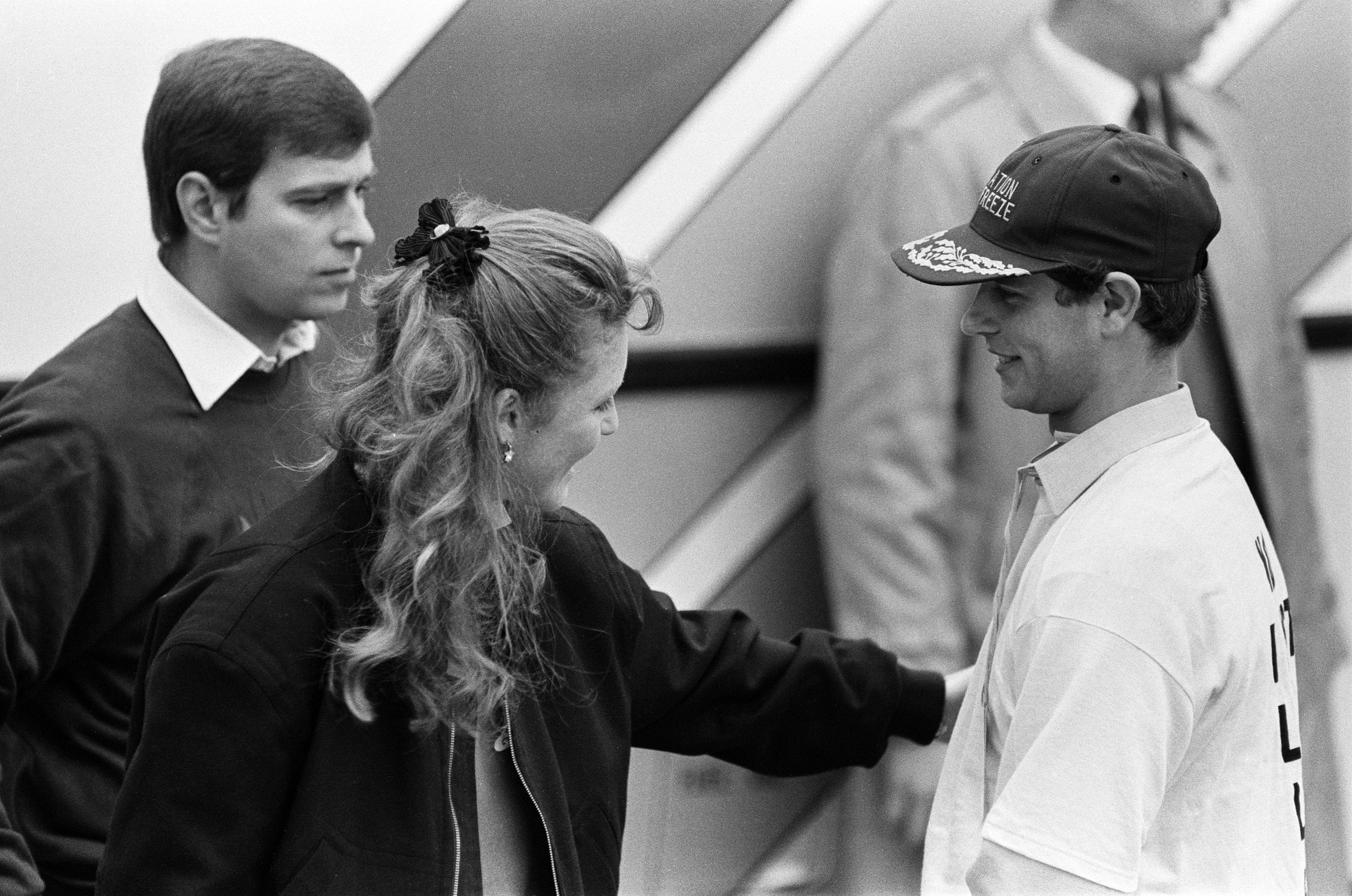 Prince Andrew, Sarah Ferguson and Prince Edward talking to each other in 1987