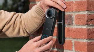 The Eufy S4 video doorbell by Anker being attached to a wall