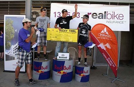 Martin Wisata announces the men's podium for 80 km. (L to R) Peter Hatton in second; Shaun Lewis in first; Craig Gordon in third