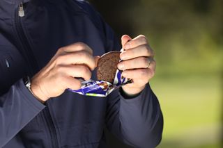 Opening the Max Golf Protein Double Choc Blueberry Cookie from its packaging