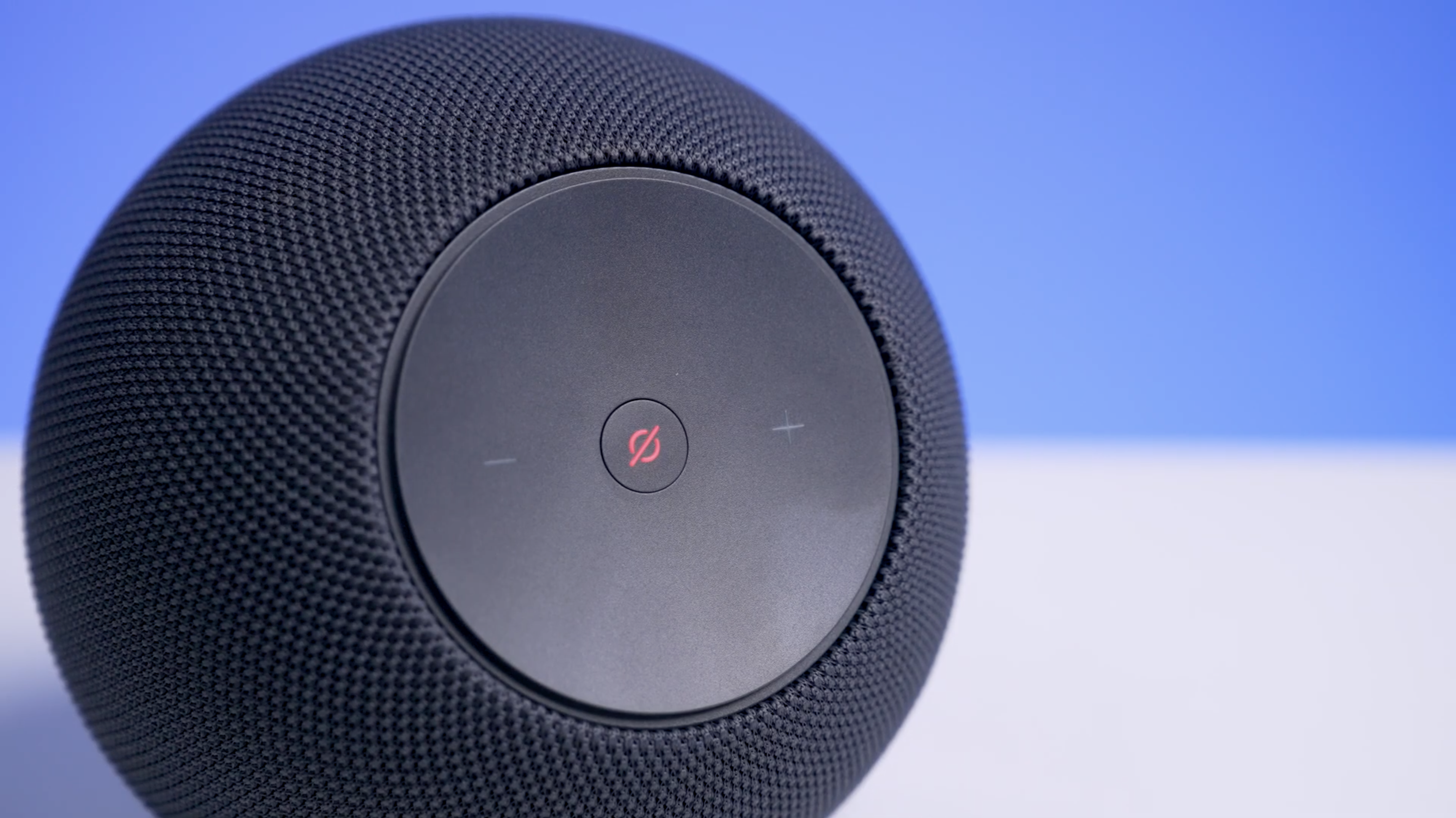 Echo Studio on a white table with a blue background