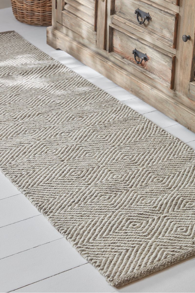 neutral runner rug and wooden storage unit