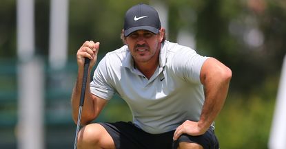 Brooks Koepka reads a putt