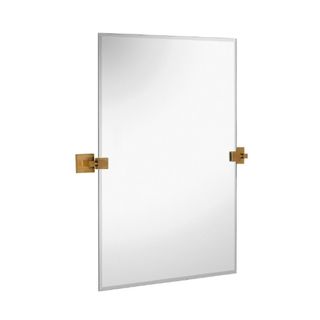 A silver rectangular mirror with brushed gold hinges on either side