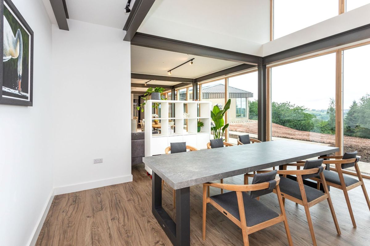 The dining area in the home with a double height roof space