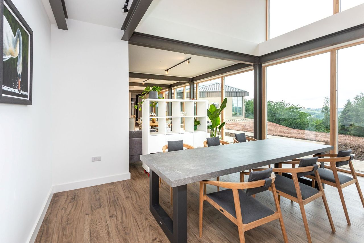The dining area in the home with a double height roof space