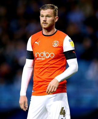 Luton’s Ryan Tunnicliffe will come up against fomer side Manchester United on Tuesday.