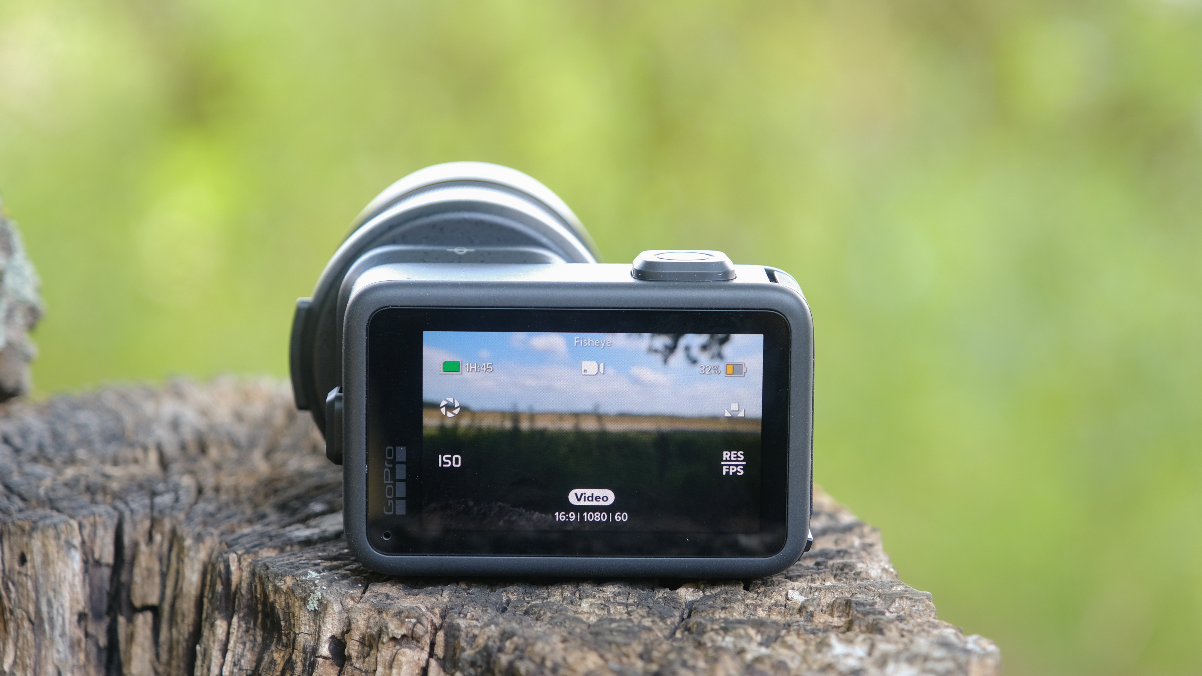 The GoPro Mission 1 ILS mirrorless camera photographed outdoors on a tree stump