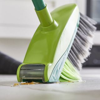 sweep broom with built in vacuum and white flooring