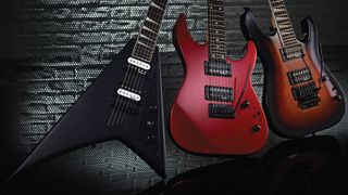 Two Jackson guitars with metal and brick background