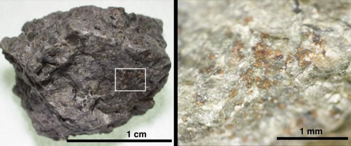 A rock fragment of Martian meteorite ALH84001 (left). An enlarged area (right) shows the orange-colored carbonate grains on the host orthopyroxene rock.