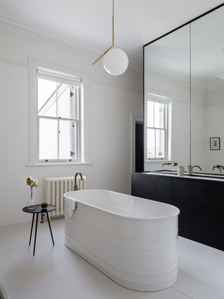 A bathroom with a white, standalone bathtub