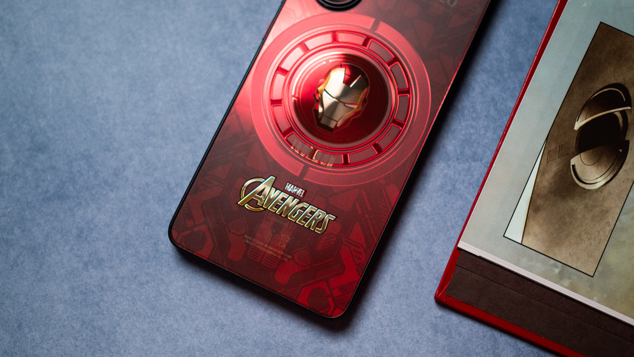 POCO X7 Pro Iron Man Edition back view next to comic