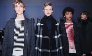 Three models stood next to each other with checked jackets on