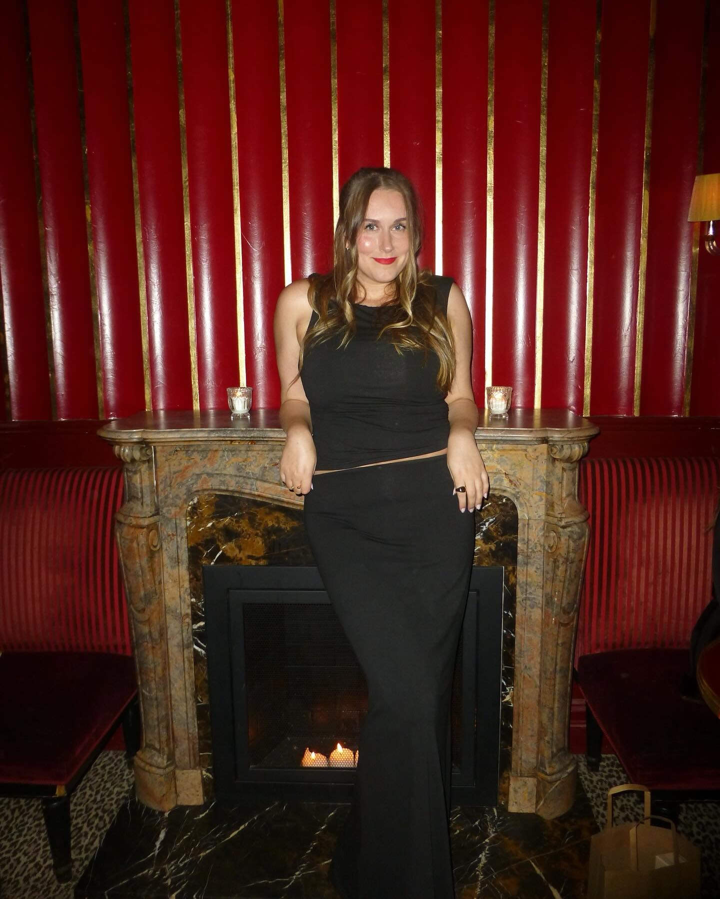 An image of WWW beauty editor Kaitlyn McLintock posing while wearing red lipstick.