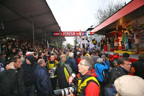 The finish chute is mobbed with fans and media
