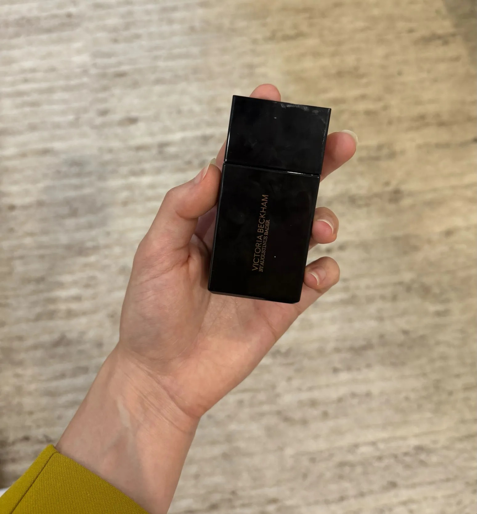 Schneider holding Victoria Beckham Beauty's The Foundation Drops.