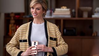 Brooklyn Decker smiles awkwardly as she holds her phone in Grace and Frankie.