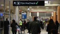 Travelers head to the TSA PreCheck line at an airport