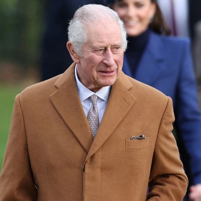 King Charles wears a camel coat as he attends church on Christmas Day with wife Queen Camilla, wearing a tan coat and matching hat