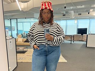 chichi wears a red and white striped hat and black and white striped shirt with some distressed jeans and loafers in a mirror selfie