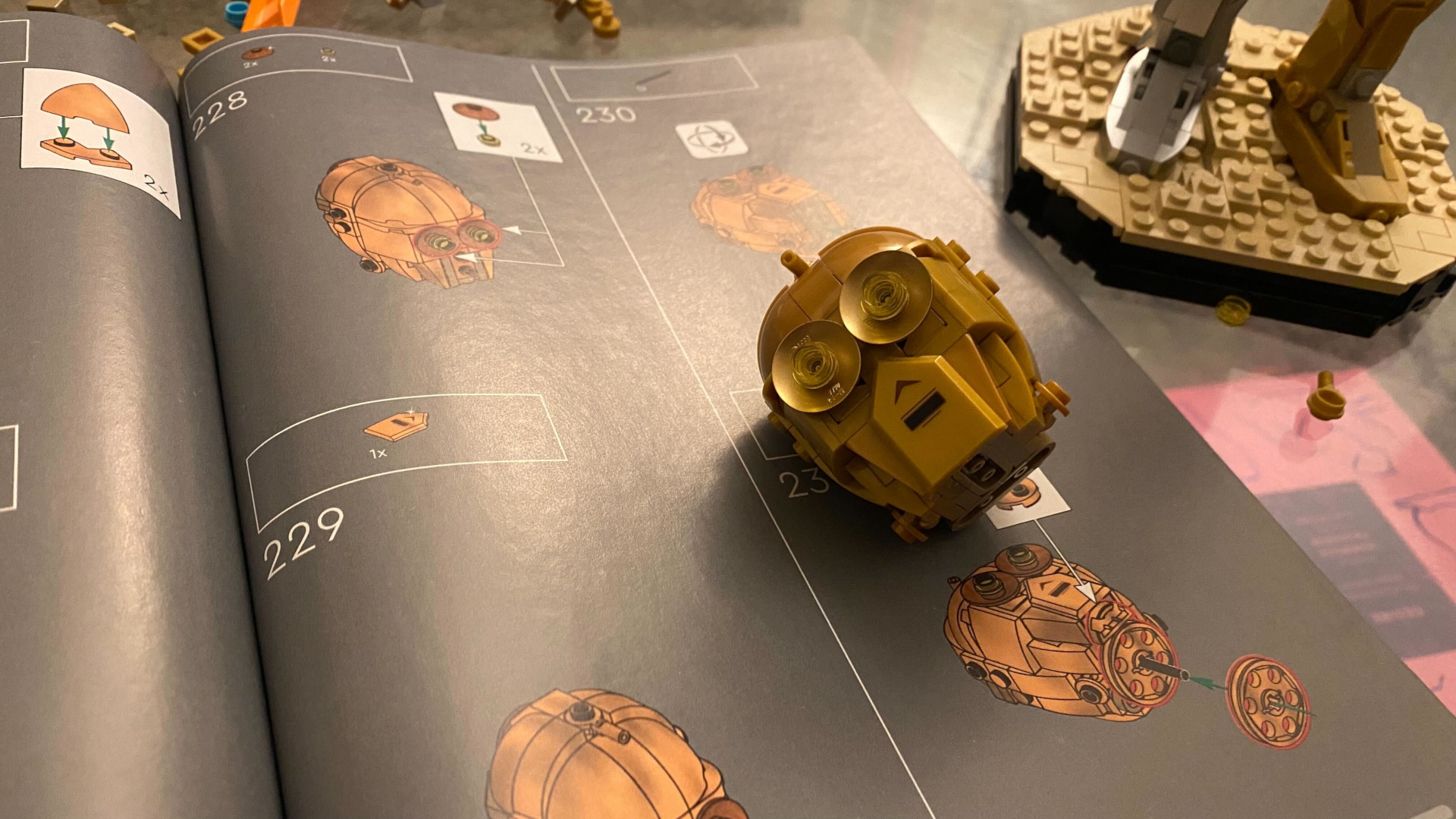 Lego C-3PO head on an instruction booklet