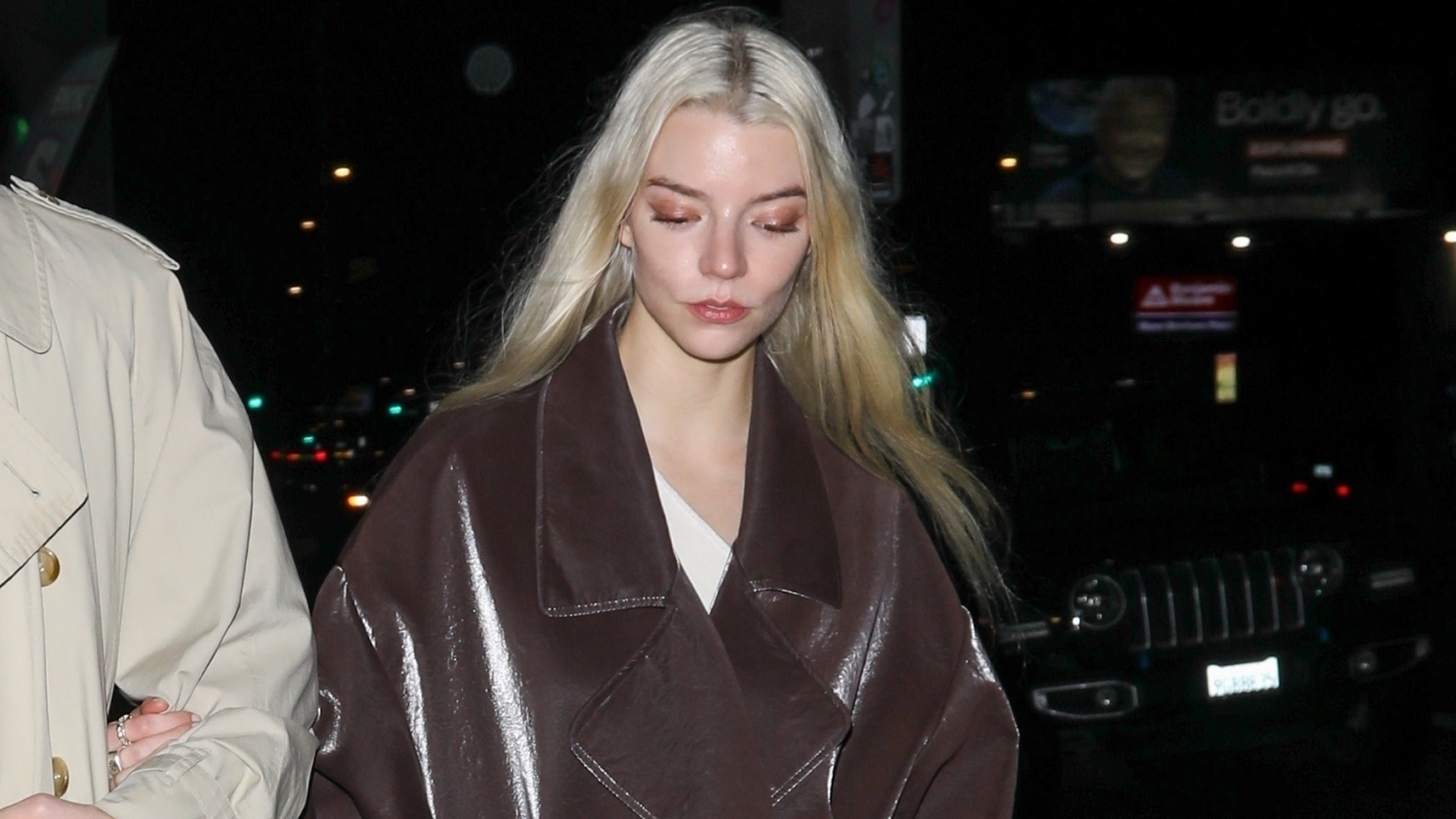 Anya Taylor-Joy styled a leather brown wrap coat inspired by Fall 2025 outerwear trends